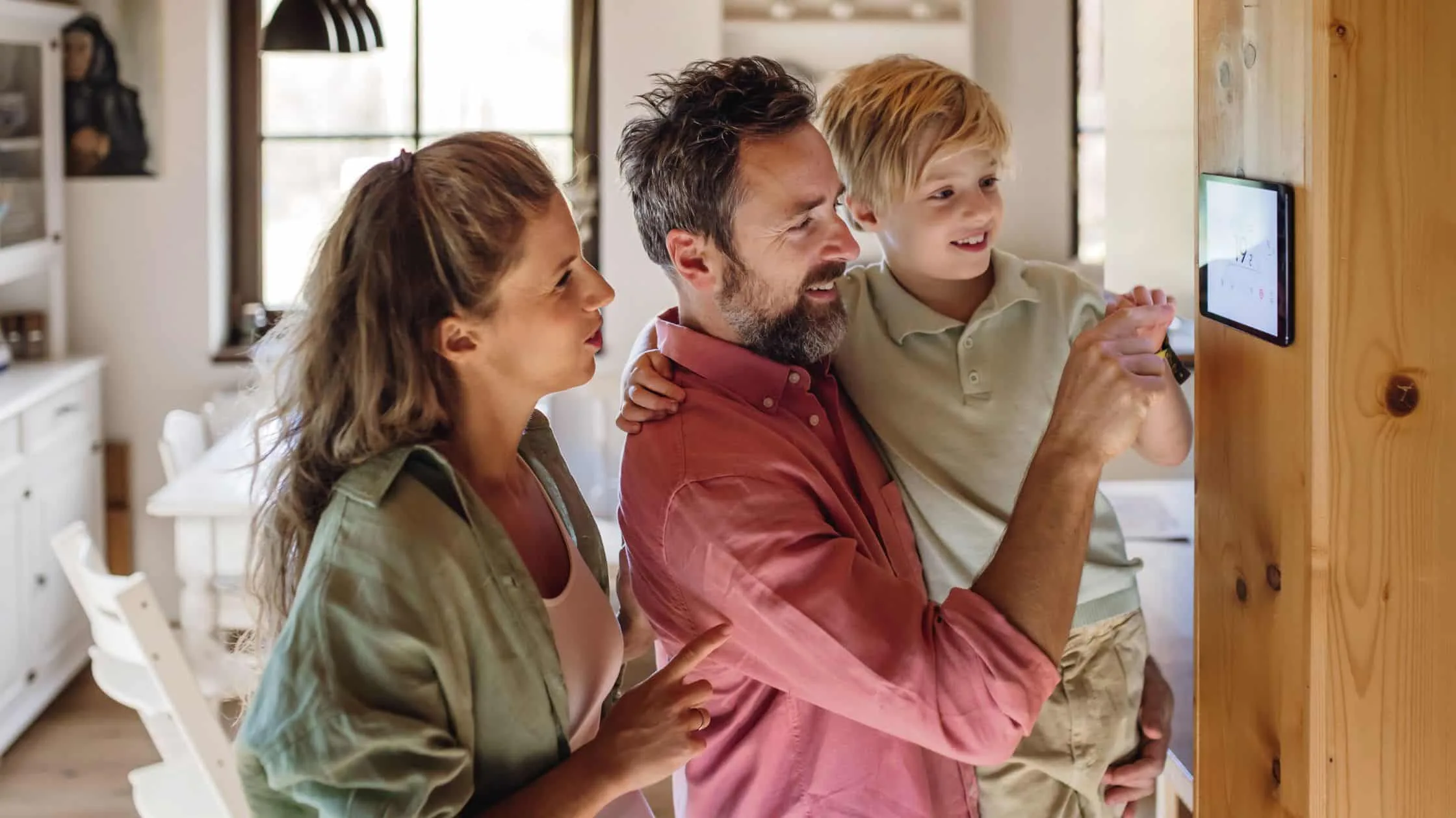 People changing new furnace thermostat - how long does it take for a furnace installation - Hamilton Home Comfort.