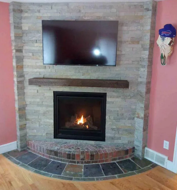 TV above a brick fireplace