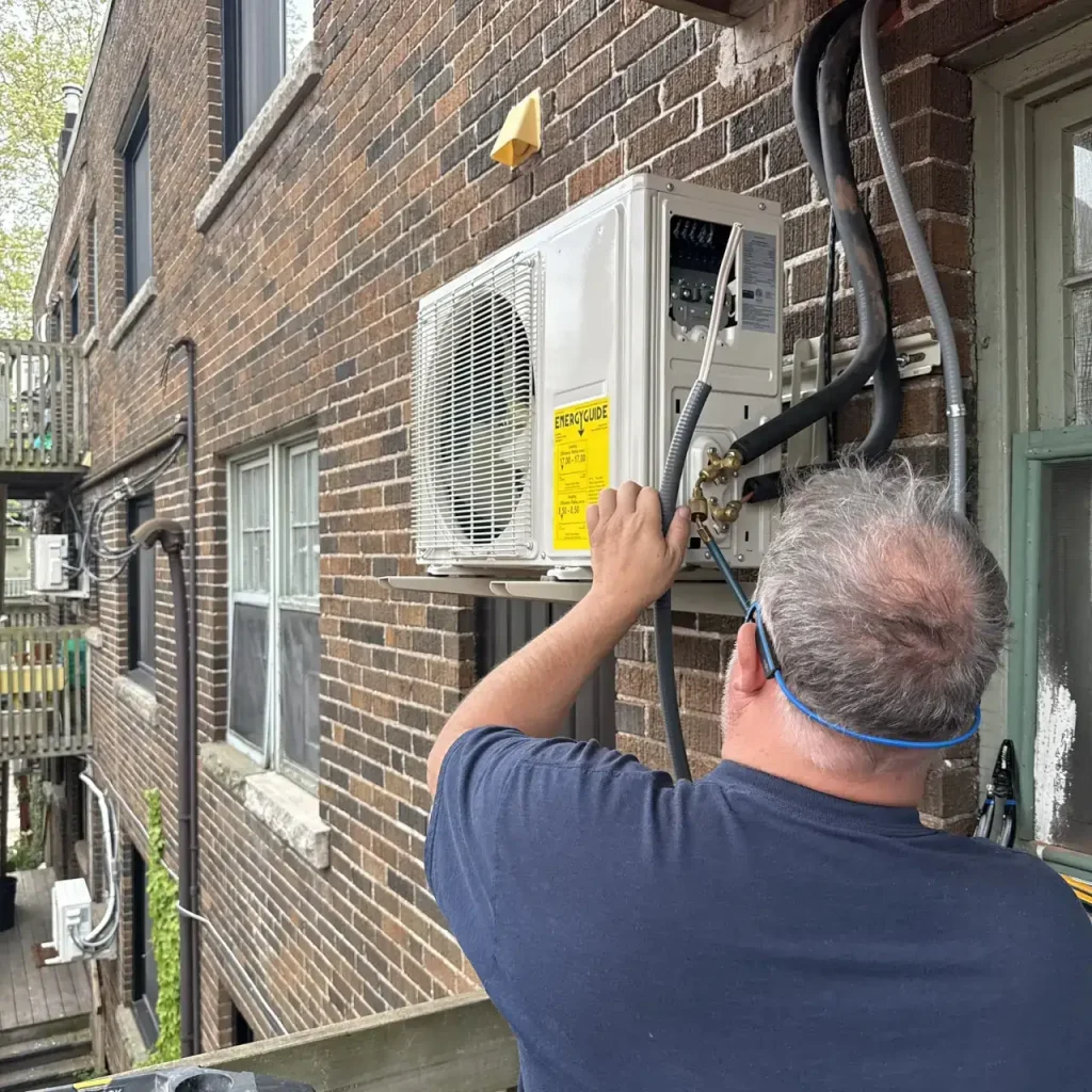 HVAC tech checking AC lines