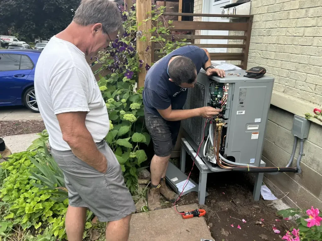 HVAC tech doing checks on a outdoor AC unit