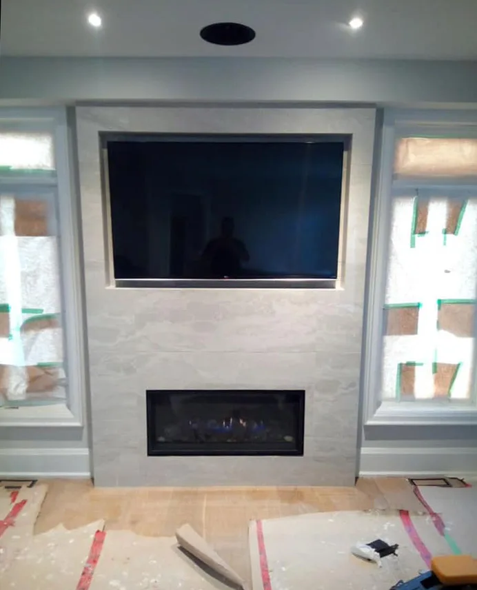 Living room fireplace under a TV