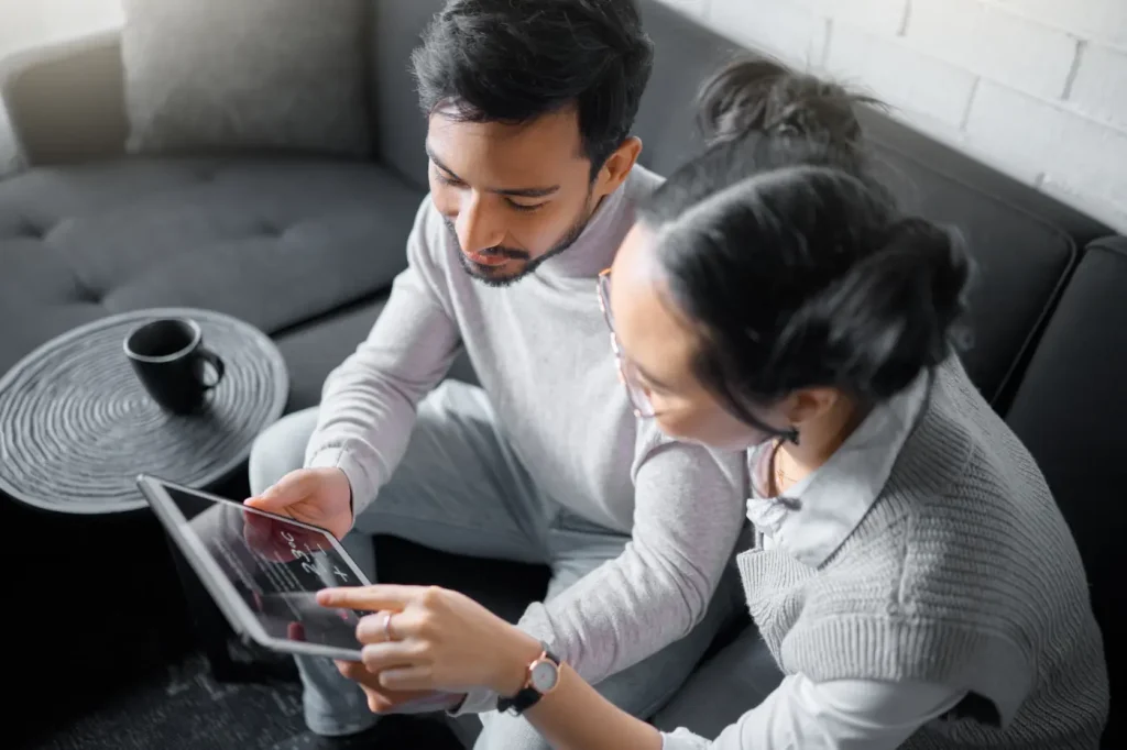 Couple looking at temperature settings for their HVAC system