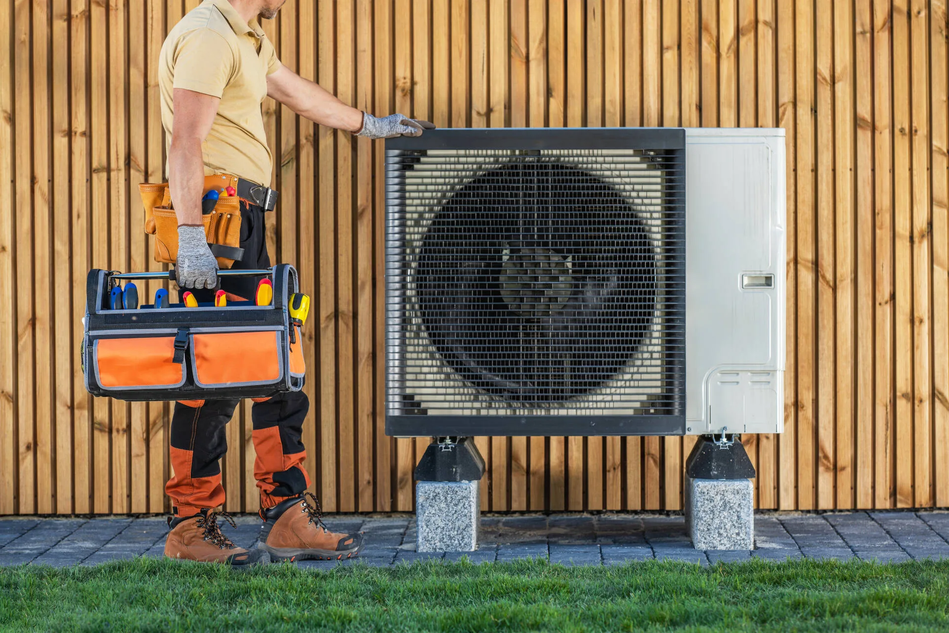 HVAC checking an outside AC unit